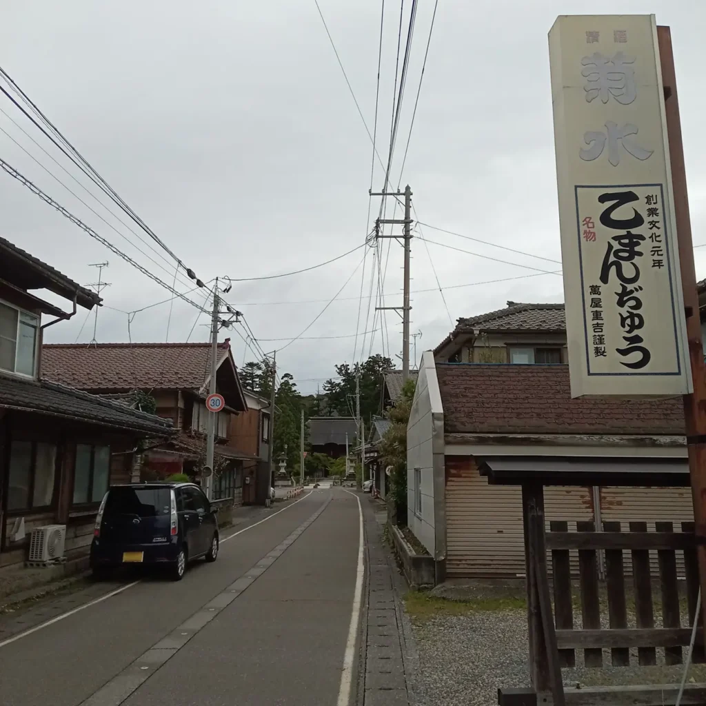 乙まんじゅうやの店の前。奥に乙宝寺が見える。